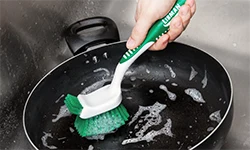 Woman changing out microfiber pad on Rinse 'n Wring Mop